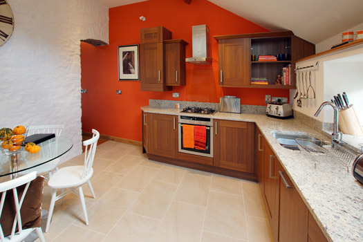 Well-equipped kitchen and dining space inside The Coach