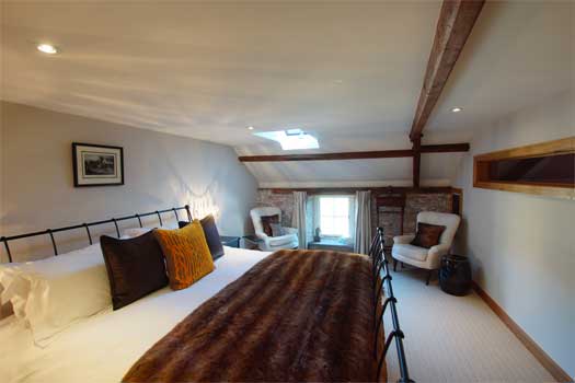 Elegant king-size bedroom at The Coach with views across the Ty Mawr Estate