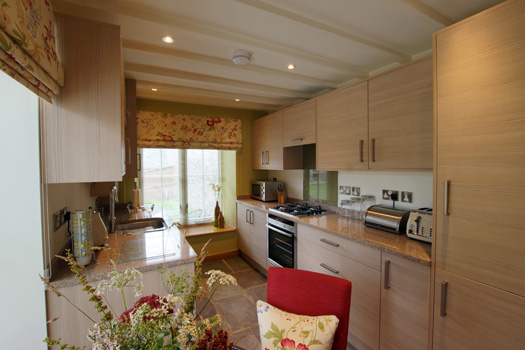 Fully equipped country kitchen and dining area inside The Dairy