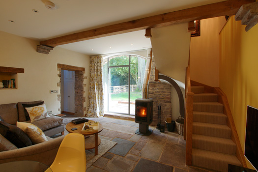Sitting room at The Laundry with wood-burning stove and period character