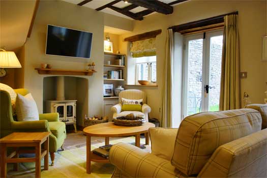 Spacious sitting room at The Bothy with wood-burning stove and comfortable seating